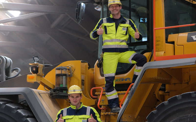 Zwei Auszubildende schauen in die Kamera 