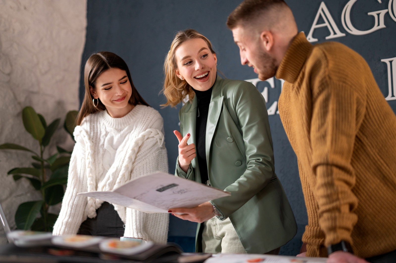 Eine Eventmanagerin erklärt einem Paar den Ablauf ihres Events. 