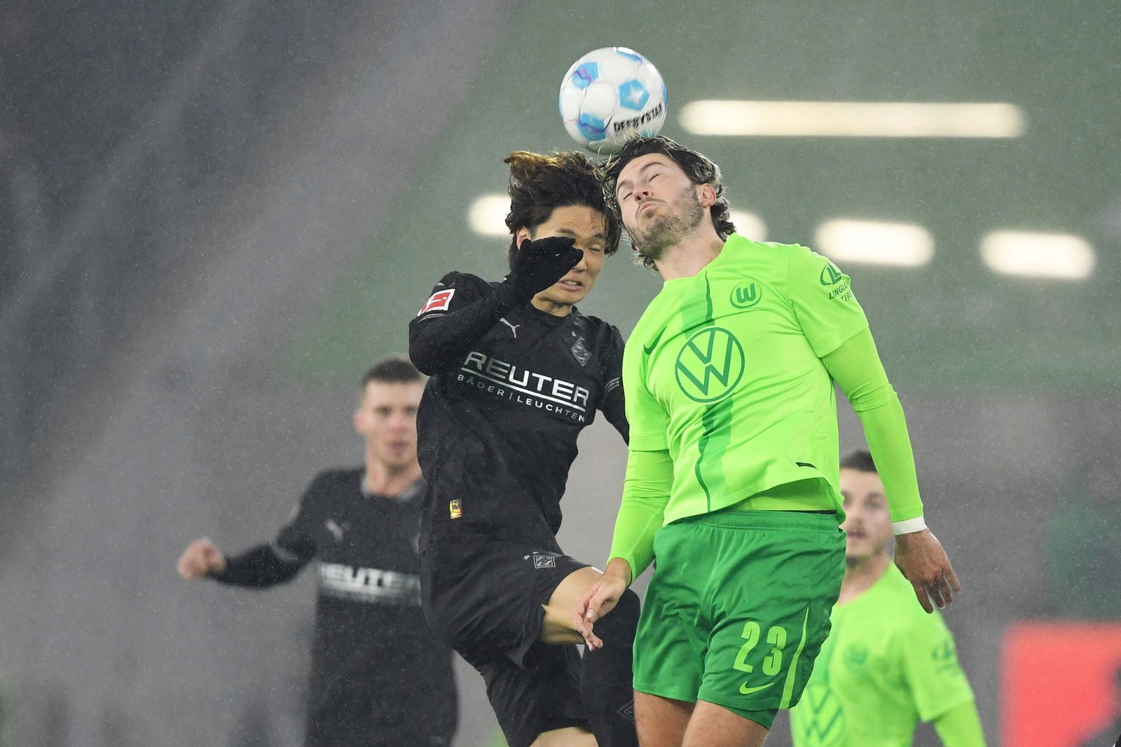 Im Kopfballduell: Wolfsburgs Jonas Wind (r) und Mönchengladbachs Ko Itakura.