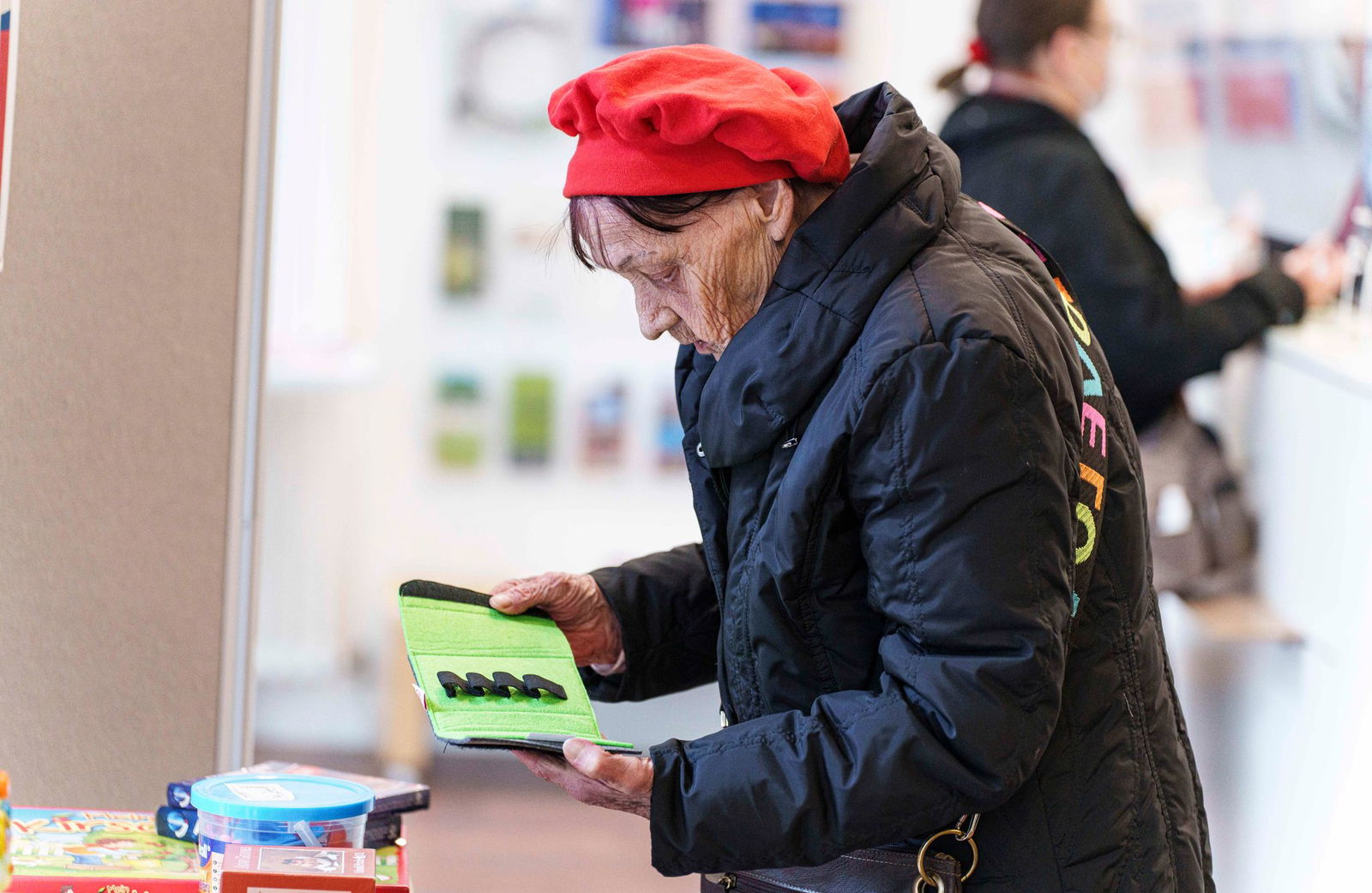 Die 83-jährige Renate aus Mainz sieht sich die Tauschwaren im Mainzer Umweltladen ganz genau an.