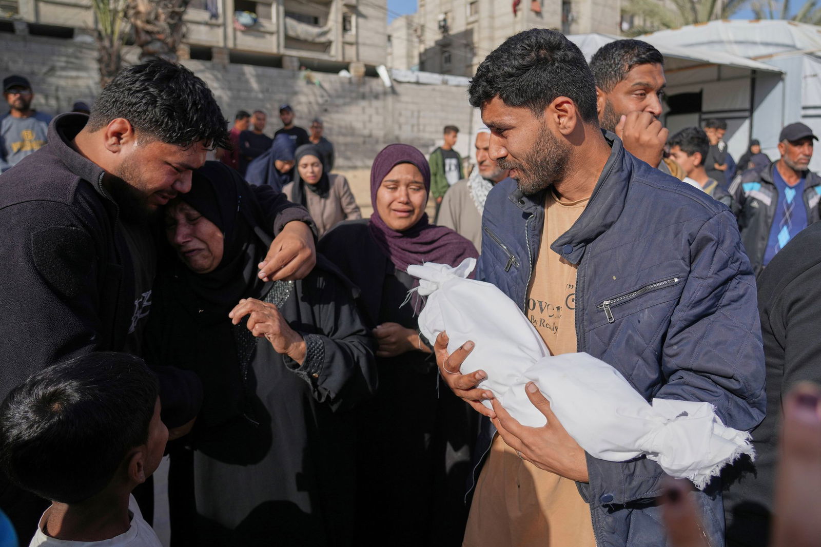 Vater mit Leiche von getötetem Kind. 