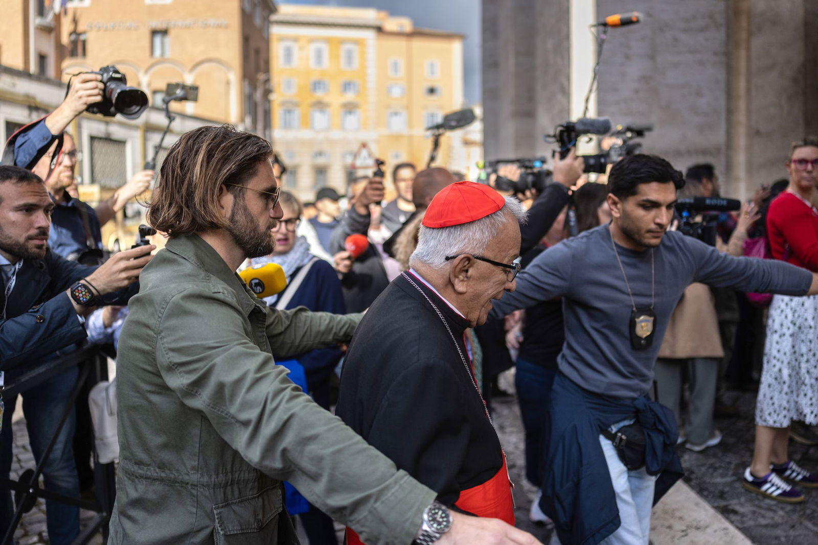 Auf dem Weg zum Vatikan kämpfen sich die Kardinäle durch eine Menge aus Journalisten und Schaulustigen.