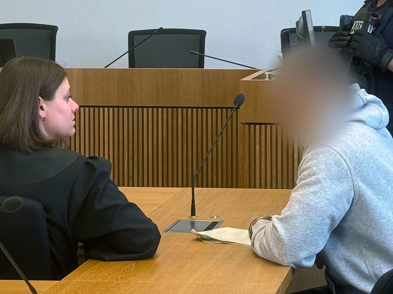 Ein mutmaßlicher Einbrecher sitzt im Stuttgarter Landgericht auf der Anklagebank und berät sich mit seiner Anwältin.