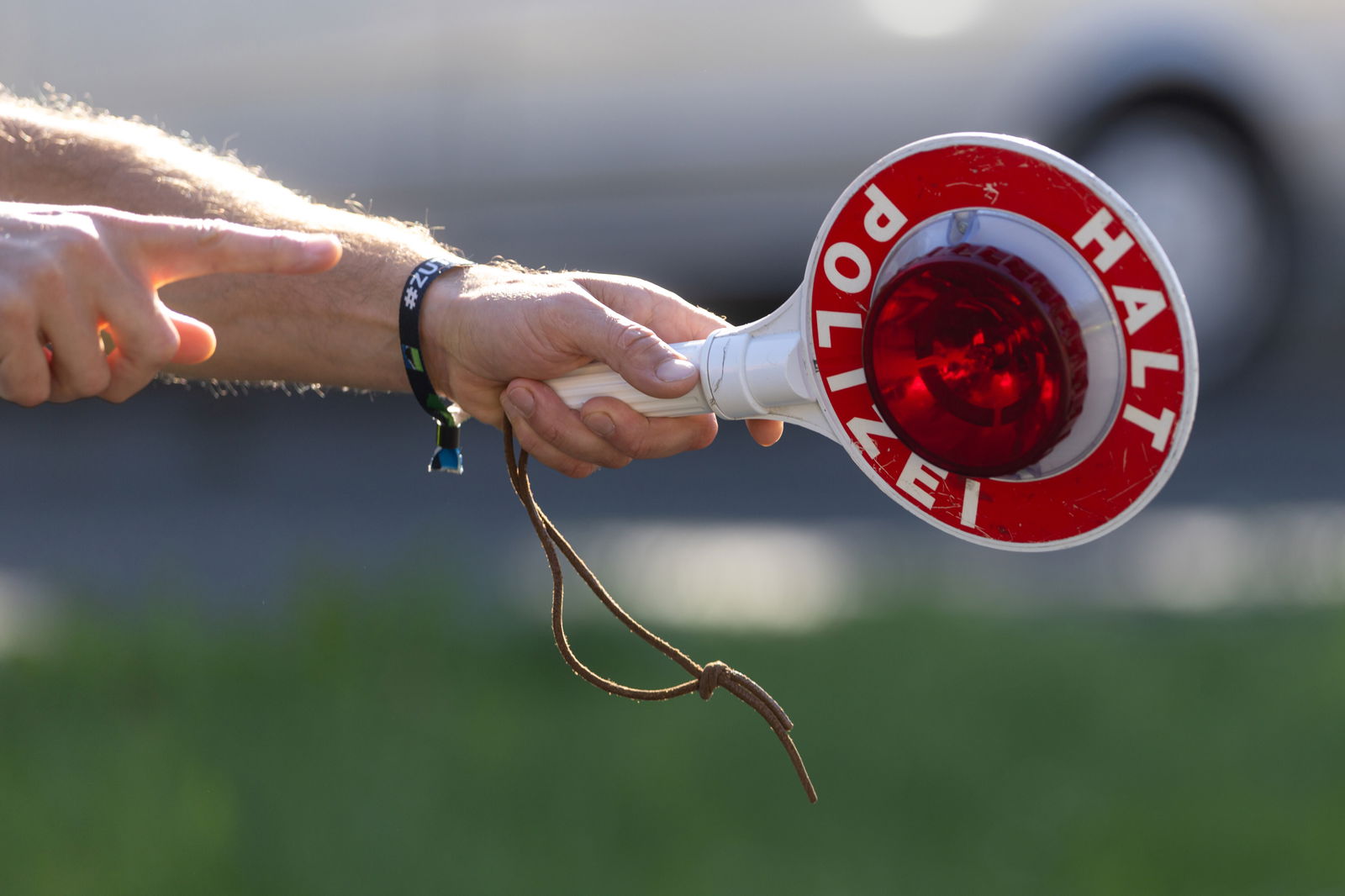 Polizist winkt mit Polizeikelle