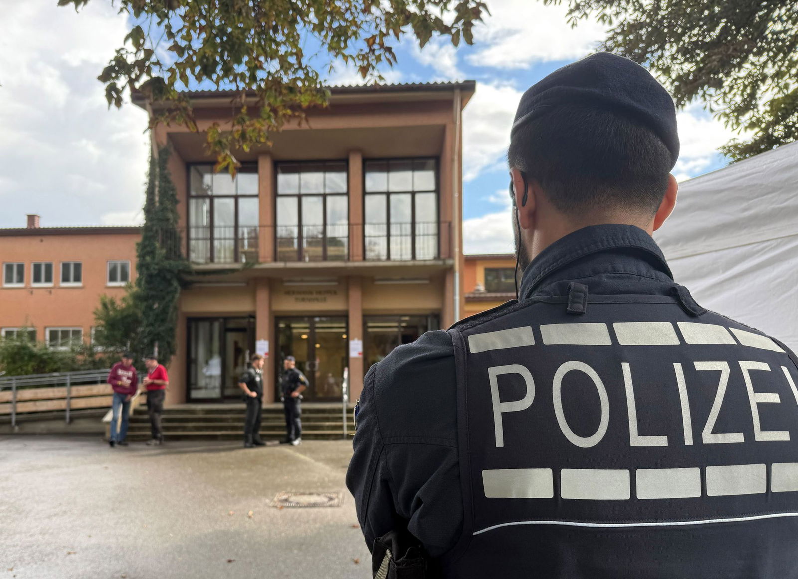 Vor der Halle in Tübingen stehen Einsatzkräfte, die Zugänge sind abgesperrt. 