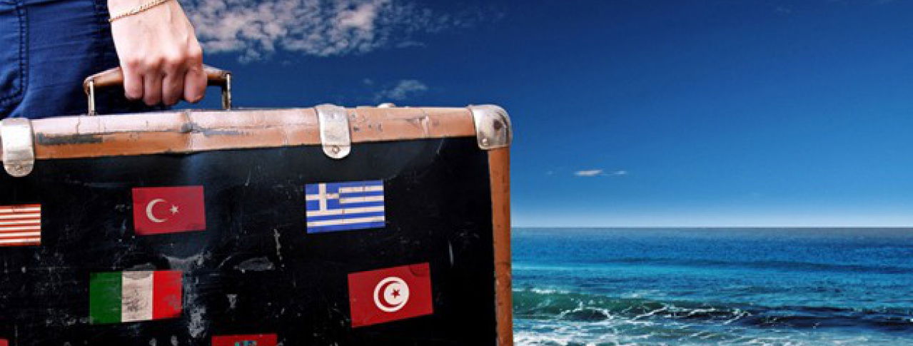 Eine Person hält einen Koffer in der Hand 