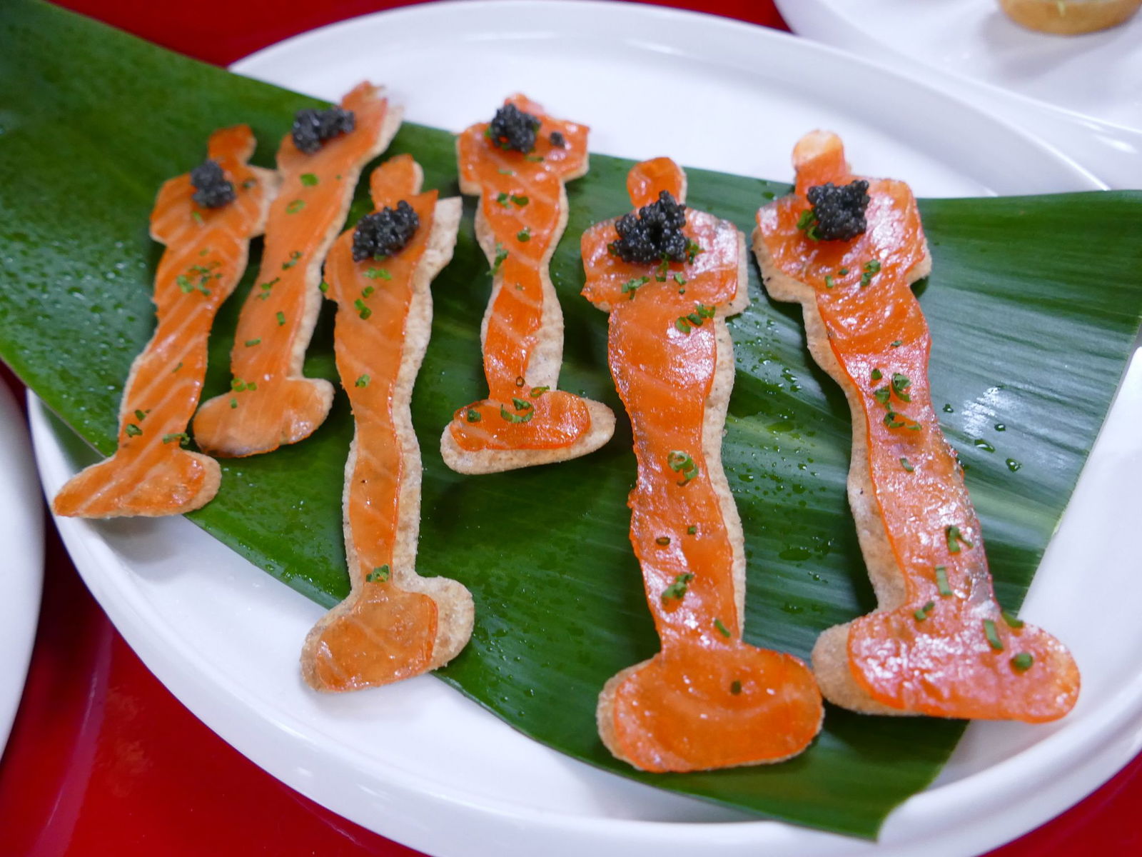 Wildlachsstreifen werden in Form einer Oscar-Trophäe zurechtgeschnitten.
