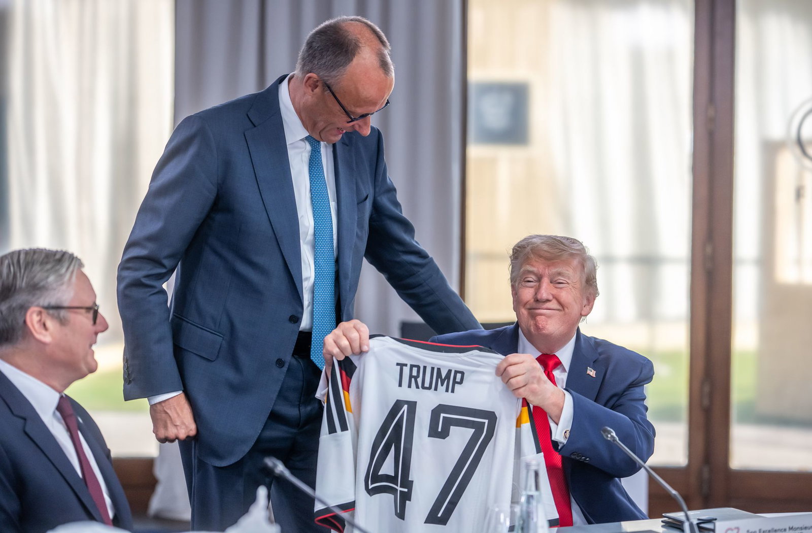 Auch für die Trikotübergabe an Trump musste Merz Kritik einstecken.