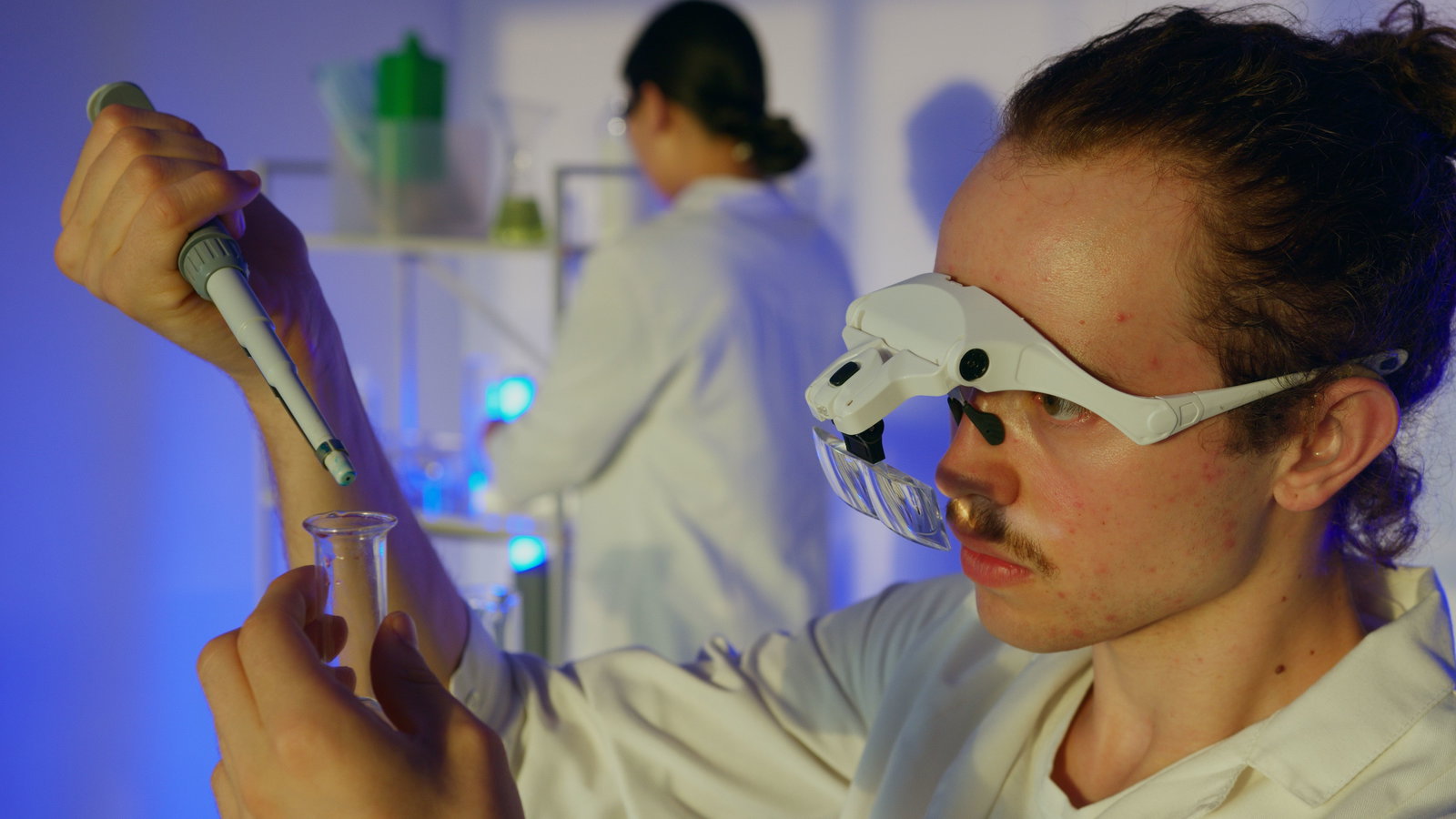 Lacklabornat mit Schutzbrille arbeitet mit Pipette 