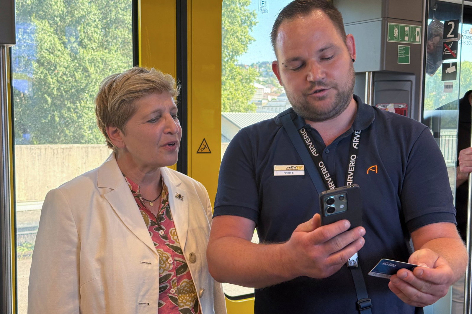 Kundenbetreuer Patrick Bleichner zeigt Verkehrsministerin Nicole Razavi (CDU) wie man eine Fahrkartenkontrolle durchführt. (Archivbild)