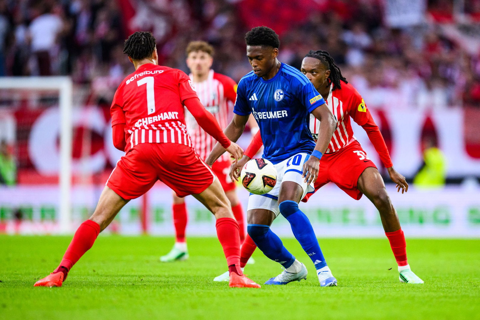 Umzingelt: Schalkes Junior Adamu (M.) gegen Ex-Club Freiburg.