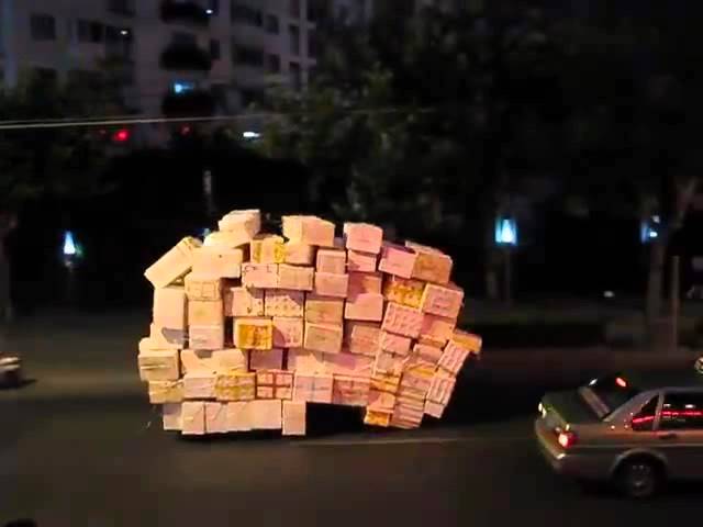 Overloaded tricycle spotted moving through the downtown streets in Shanghai